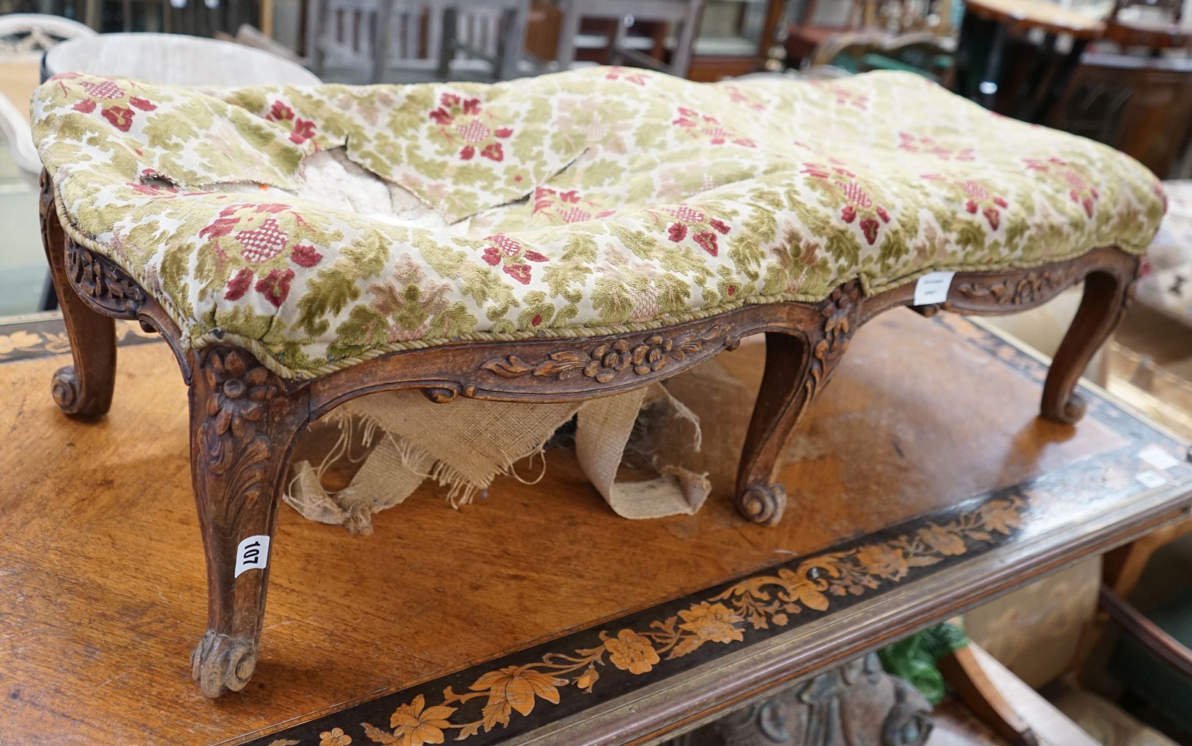 A Victorian walnut fender stool requiring re-upholstery, length 108cm, depth 40cm, height 33cm